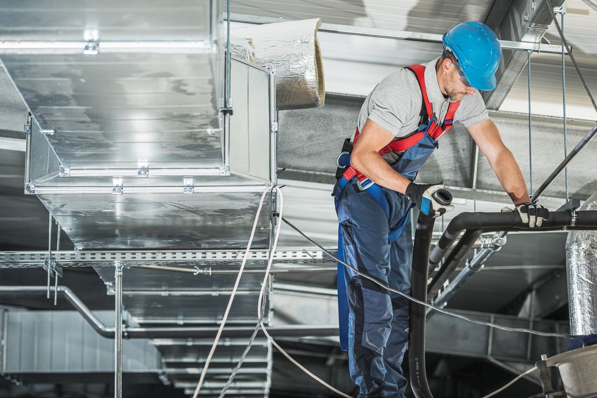 HVAC technician working on ductwork